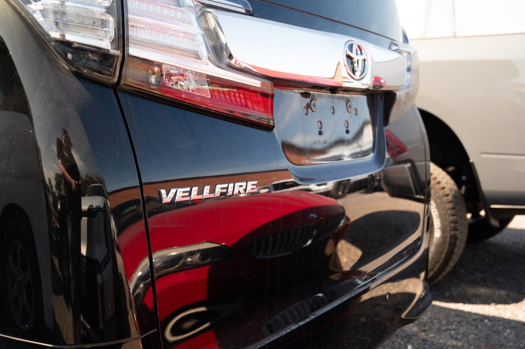 The Vellfire badge on the rear quarter of a black Toyota Vellfire
